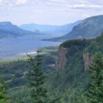 Scenic river valley with lush green forests and cliffs, perfect for eco-friendly tours.